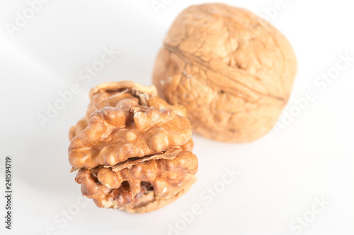 Shelled walnuts and walnut kernels. Stock Photo.