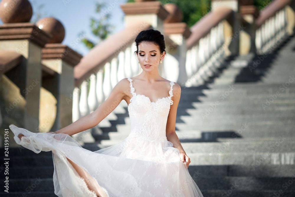 Naklejka premium fashion photo of beautiful woman with dark hair in luxurious wedding dress