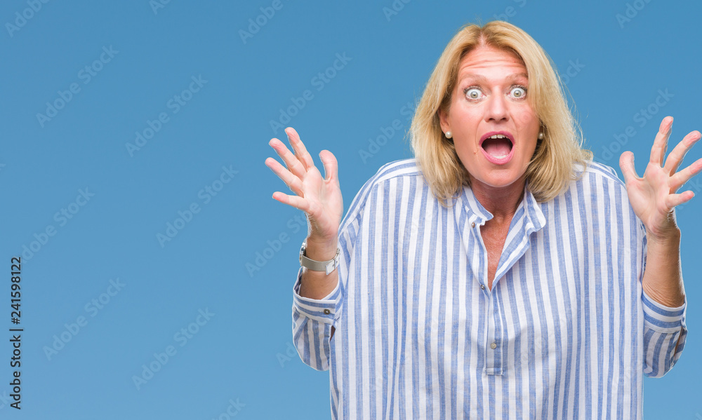 Middle age blonde business woman over isolated background celebrating crazy and amazed for success with arms raised and open eyes screaming excited. Winner concept Middle age blonde business woman over isolated background celebrating crazy and amazed for success with arms raised and open eyes screaming excited. Winner concept