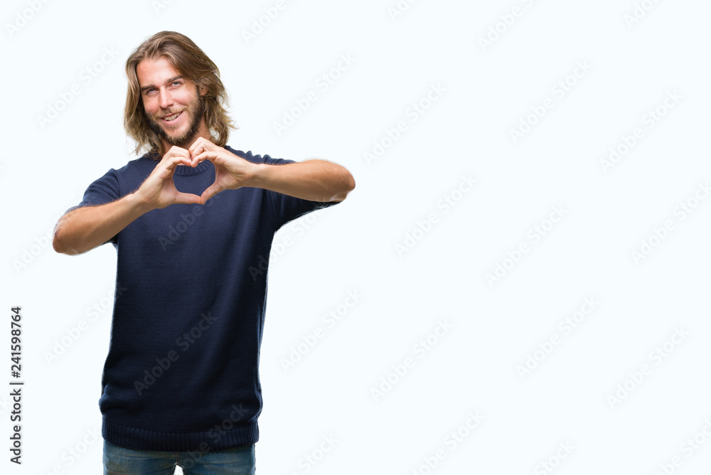 Young handsome man with long hair wearing winter sweater over isolated background smiling in love showing heart symbol and shape with hands. Romantic concept. Young handsome man with long hair wearing winter sweater over isolated background smiling in love showing heart symbol and shape with hands. Romantic concept.