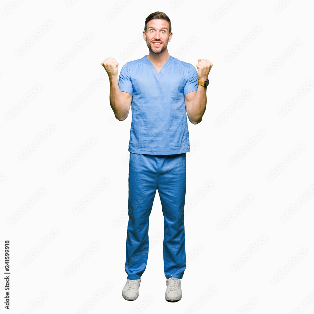 Handsome doctor man wearing medical uniform over isolated background celebrating surprised and amazed for success with arms raised and open eyes. Winner concept. Handsome doctor man wearing medical uniform over isolated background celebrating surprised and amazed for success with arms raised and open eyes. Winner concept.