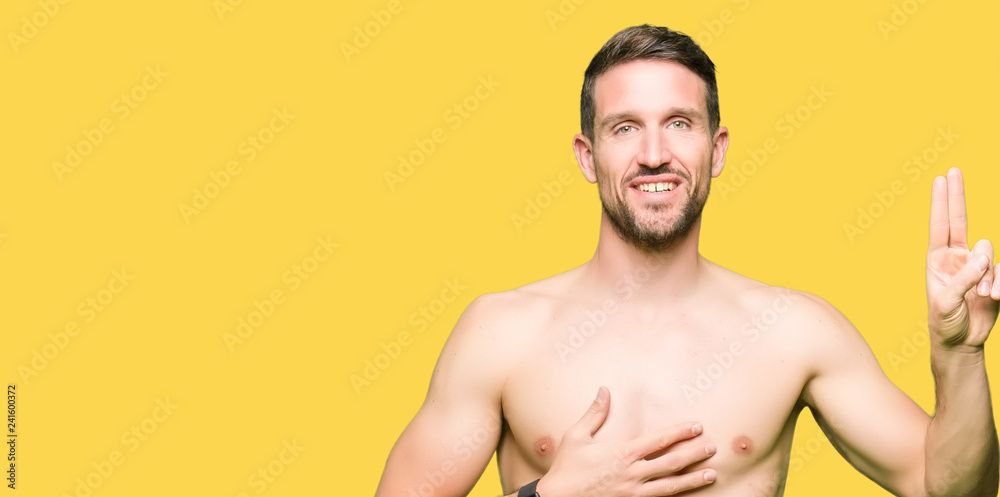 Handsome shirtless man showing nude chest Swearing with hand on chest and fingers, making a loyalty promise oath