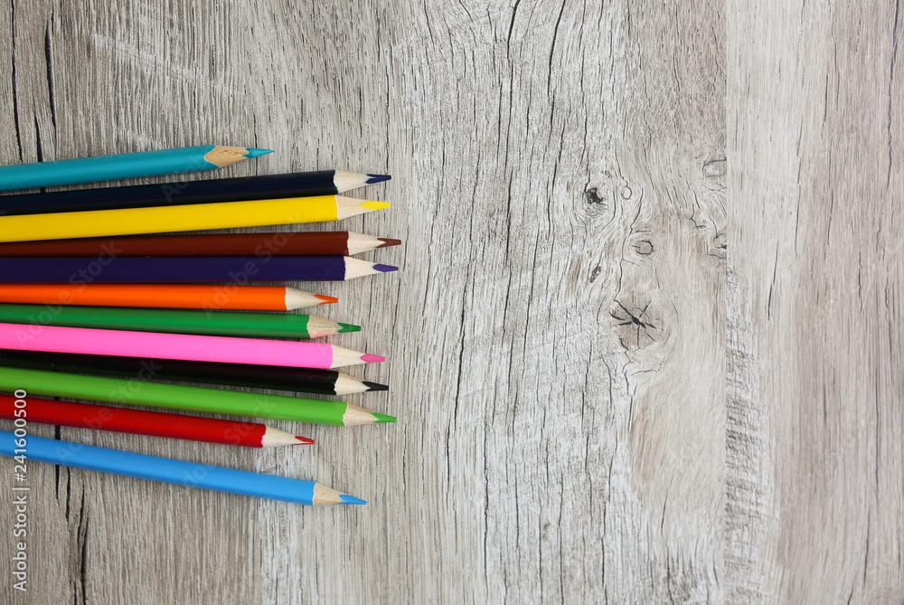 Color pencils with sharpener lying on wooden natural background. Back to school concept. Colorful art studying and painting process. Drawing with pencils. Copy space place for postcard wish. Color pencils with sharpener lying on wooden natural background. Back to school concept. Colorful art studying and painting process. Drawing with pencils. Copy space place for postcard wish.