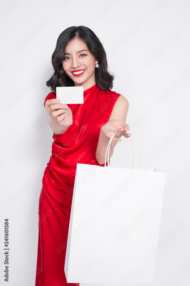 Shopping Woman concept, portrait or isolated an beautiful Asian woman wearing dress with holding shopping bags and credit cards. Shopping Woman concept, portrait or isolated an beautiful Asian woman wearing dress with holding shopping bags and credit cards.