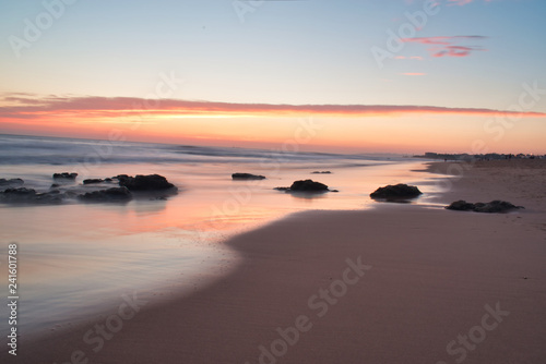 Fototapeta Naklejka Na Ścianę i Meble -  Beautiful Calming Sunrise Vacation Landscape Warm Colors Rocks on Shore Coast