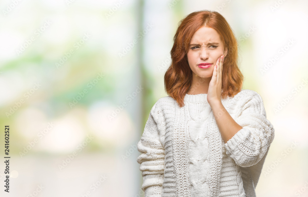 Young beautiful woman over isolated background wearing winter sweater touching mouth with hand with painful expression because of toothache or dental illness on teeth. Dentist concept.