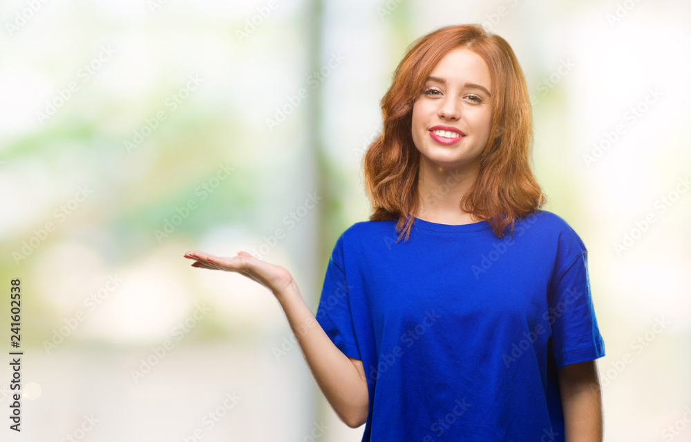 Young beautiful woman over isolated background smiling cheerful presenting and pointing with palm of hand looking at the camera. Young beautiful woman over isolated background smiling cheerful presenting and pointing with palm of hand looking at the camera.