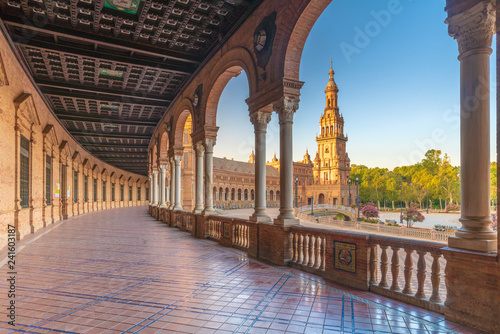 Sunrise on the old tower seen from colonnade of the semi-circular portico, Plaza de Espana, Seville, Andalusia, Spain photo