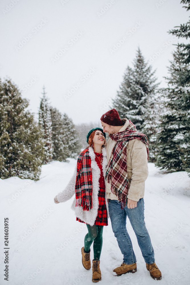 Beautiful young people couple lovers on a date in winter park , a man loves a woman a date Valentine's Day in nature.