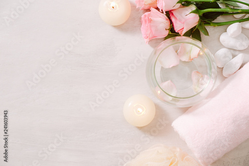 Spa settings with roses. Spa theme with candles and flowers on table.