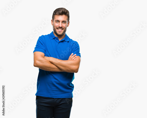 Young handsome man over isolated background happy face smiling with crossed arms looking at the camera. Positive person.