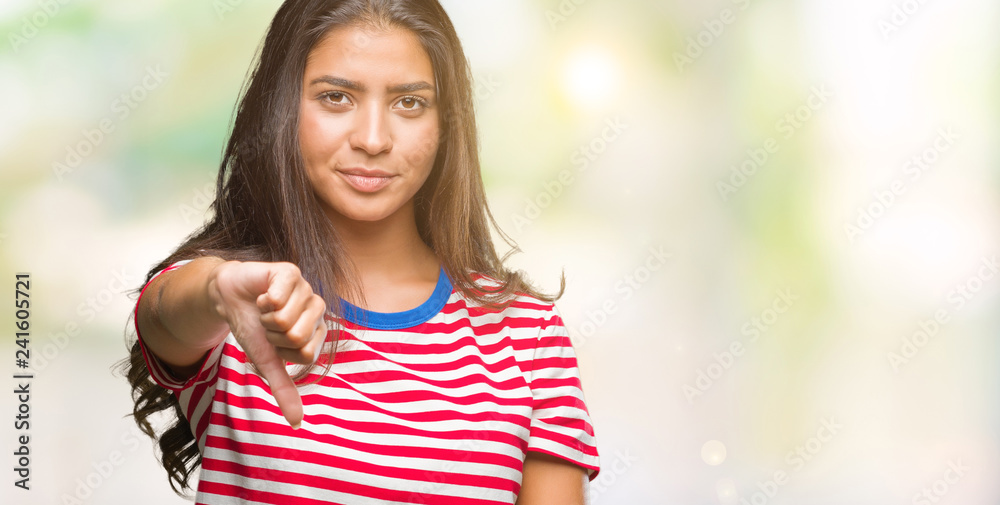 Young beautiful arab woman over isolated background looking unhappy and angry showing rejection and negative with thumbs down gesture. Bad expression. Young beautiful arab woman over isolated background looking unhappy and angry showing rejection and negative with thumbs down gesture. Bad expression.