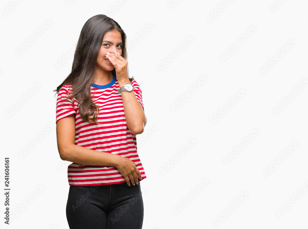 Young beautiful arab woman over isolated background smelling something stinky and disgusting, intolerable smell, holding breath with fingers on nose. Bad smells concept. Young beautiful arab woman over isolated background smelling something stinky and disgusting, intolerable smell, holding breath with fingers on nose. Bad smells concept.