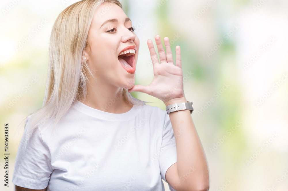 Young blonde woman over isolated background shouting and screaming loud to side with hand on mouth. Communication concept. Young blonde woman over isolated background shouting and screaming loud to side with hand on mouth. Communication concept.
