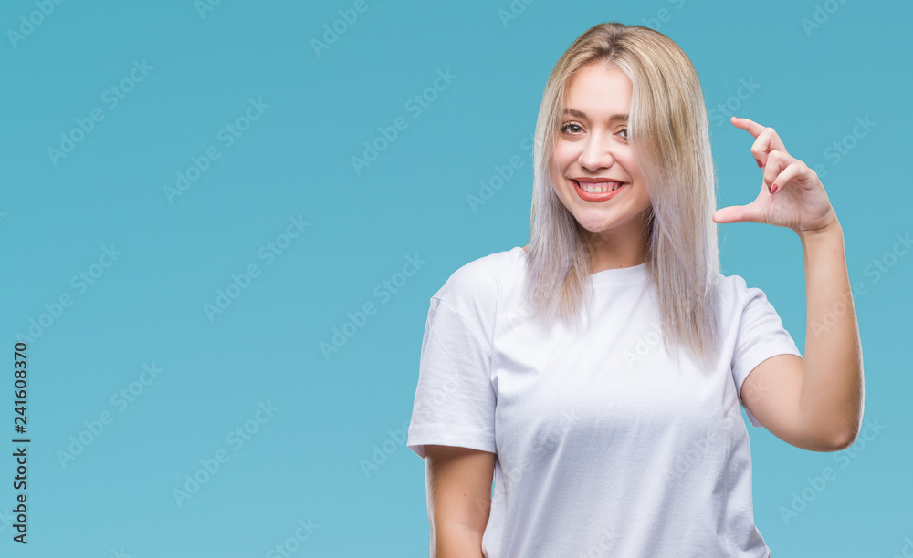 Young blonde woman over isolated background smiling and confident gesturing with hand doing size sign with fingers while looking and the camera. Measure concept. Young blonde woman over isolated background smiling and confident gesturing with hand doing size sign with fingers while looking and the camera. Measure concept.
