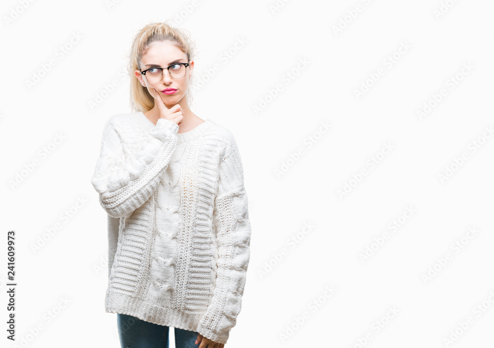 Young beautiful blonde woman wearing glasses over isolated background with hand on chin thinking about question, pensive expression. Smiling with thoughtful face. Doubt concept. Young beautiful blonde woman wearing glasses over isolated background with hand on chin thinking about question, pensive expression. Smiling with thoughtful face. Doubt concept.