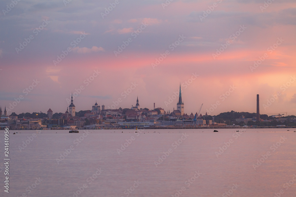 Amazing old Tallinn cityscape from the water at colorful pink sunset