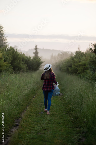single girl meets sunrise in a misty morning in a field in summer © Liliya