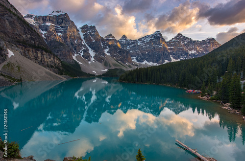 The Moraine lake sunset with snow with turquoise lake and cloudy sunset sky