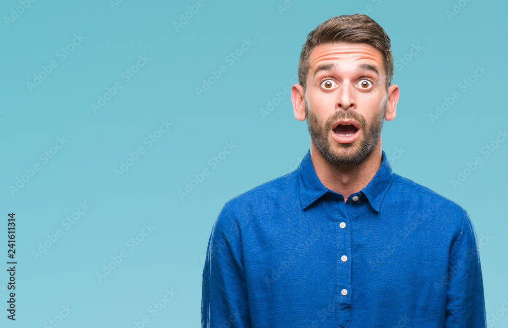 Young handsome man over isolated background afraid and shocked with surprise expression, fear and excited face. Young handsome man over isolated background afraid and shocked with surprise expression, fear and excited face.