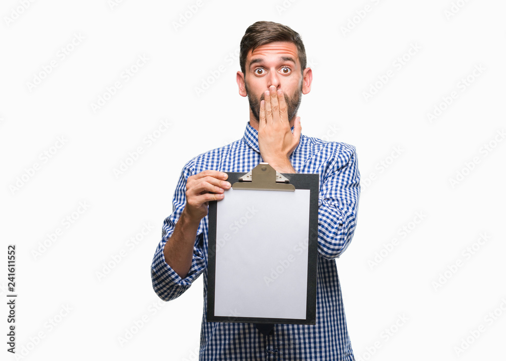 Young handsome business man holding clipboard over isolated background cover mouth with hand shocked with shame for mistake, expression of fear, scared in silence, secret concept Young handsome business man holding clipboard over isolated background cover mouth with hand shocked with shame for mistake, expression of fear, scared in silence, secret concept