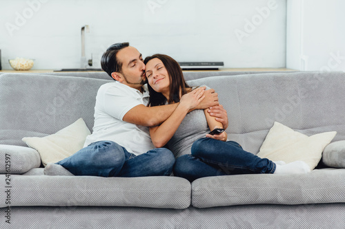 A woman and a man watch TV