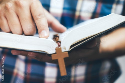 фотографія Man holding and reading the holy Christian Bible