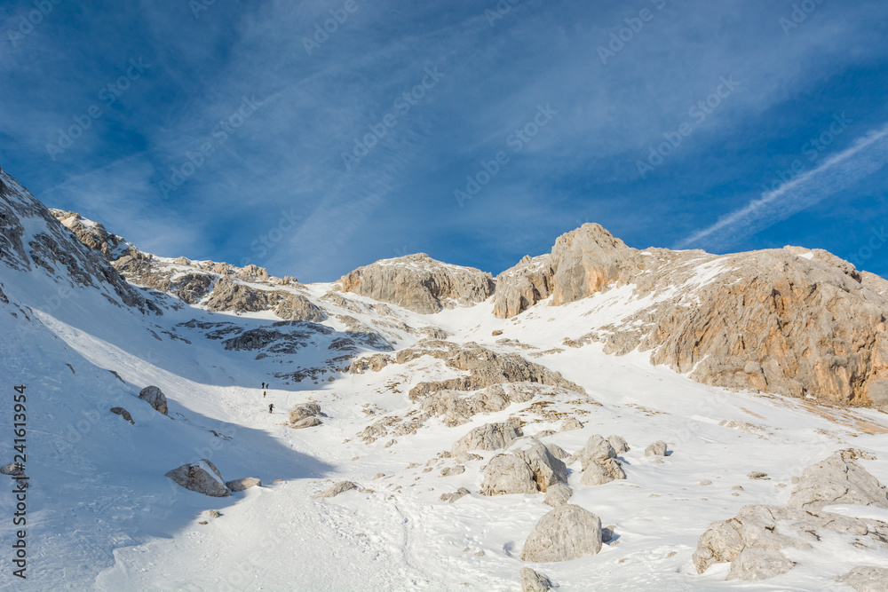 Spectacular winter mountain panorama with peaks covered with early snow.