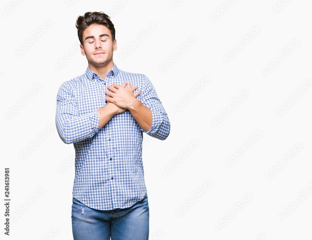 Young handsome business man over isolated background smiling with hands on chest with closed eyes and grateful gesture on face. Health concept. Young handsome business man over isolated background smiling with hands on chest with closed eyes and grateful gesture on face. Health concept.