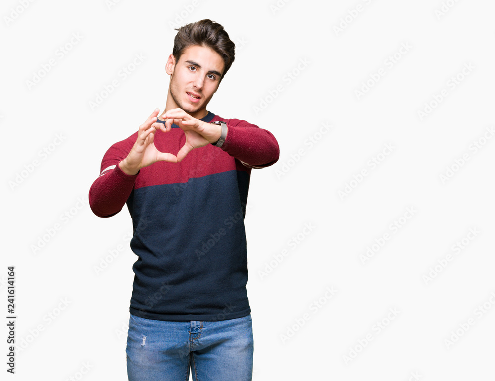 Young handsome man over isolated background smiling in love showing heart symbol and shape with hands. Romantic concept. Young handsome man over isolated background smiling in love showing heart symbol and shape with hands. Romantic concept.