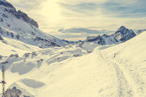 Trail running through spectacular winnter mountain landscape. © anzebizjan