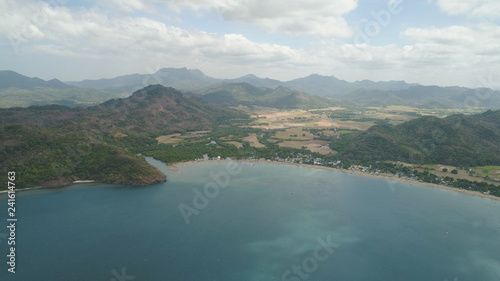 Aerial view of seashore with beach, lagoons and coral reefs. Philippines, Luzon. Ocean coastline with turquoise water. Tropical landscape in Asia.