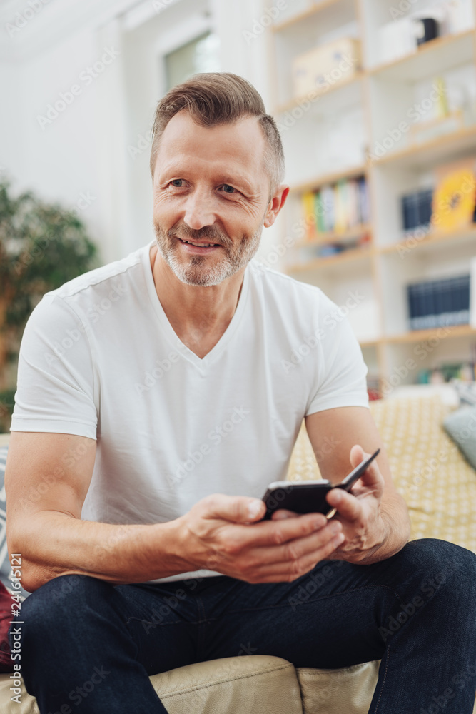 Portrait of man with cellphone, sitting on couch Portrait of man with cellphone, sitting on couch