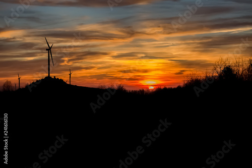 Fantastic sunset view at the top of the mountains, with wind turbines