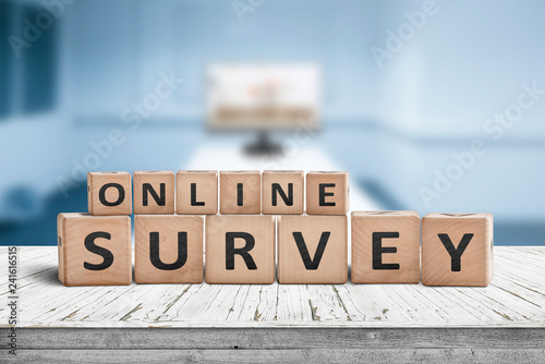 Online survey sign on a table in a blue room