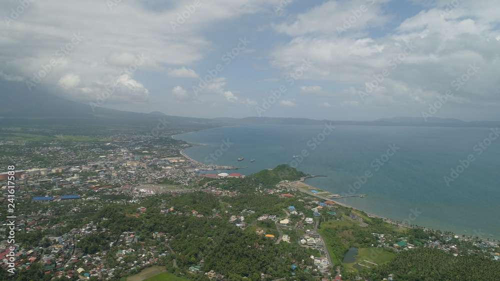 Aerial view city Legazpi in background Mayon volcano. Tropical landscape city near volcano on seashore, Philippines, Luzon.