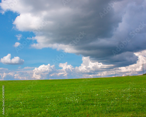 bright green country field under dramatic rolling clouds © Ryan