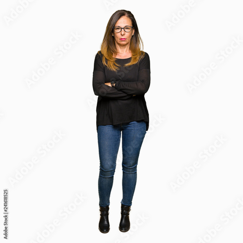 Beautiful middle age woman wearing glasses skeptic and nervous, disapproving expression on face with crossed arms. Negative person.
