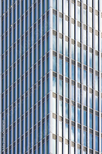 Angle modern business building skyscraper blue glass and aluminum, white square. Windows of facade. Modern apartment buildings in new neighborhood. Windows of a building, texture.