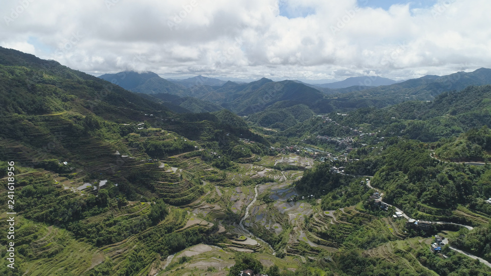 Aerial view of rice terraces on the slopes of the mountains, Banaue, Philippines. Rice cultivation in the North Batad. Mountains covered forest, trees. Philippine Cordilleras.