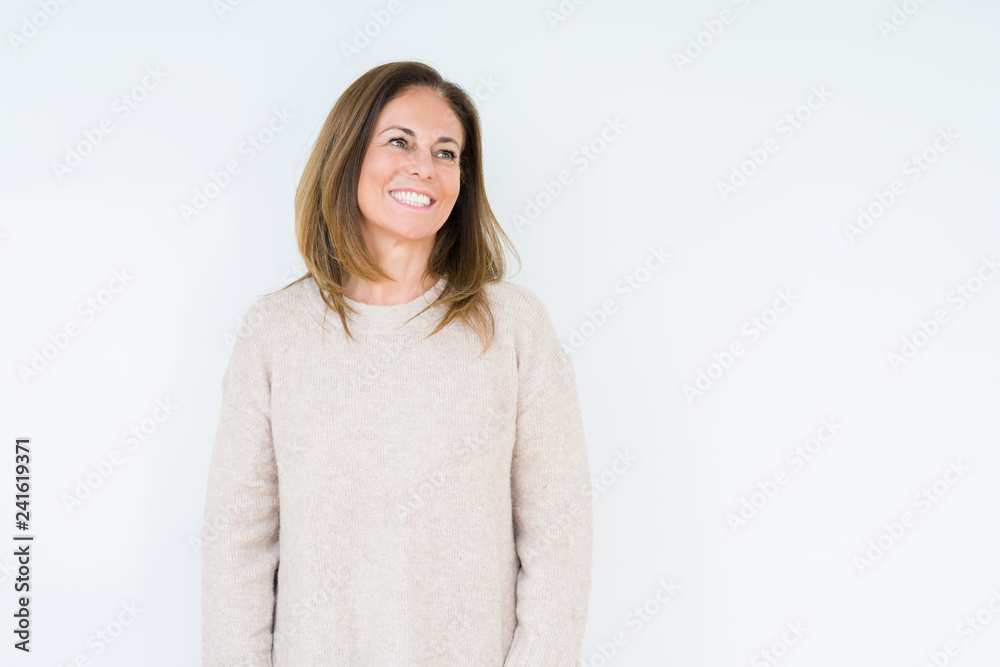 Beautiful middle age woman over isolated background looking away to side with smile on face, natural expression. Laughing confident. Beautiful middle age woman over isolated background looking away to side with smile on face, natural expression. Laughing confident.