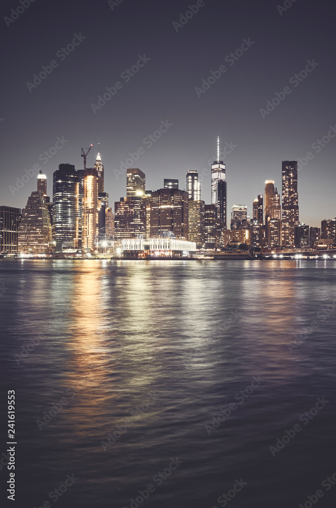 New York City skyline at night, color toned picture, USA.