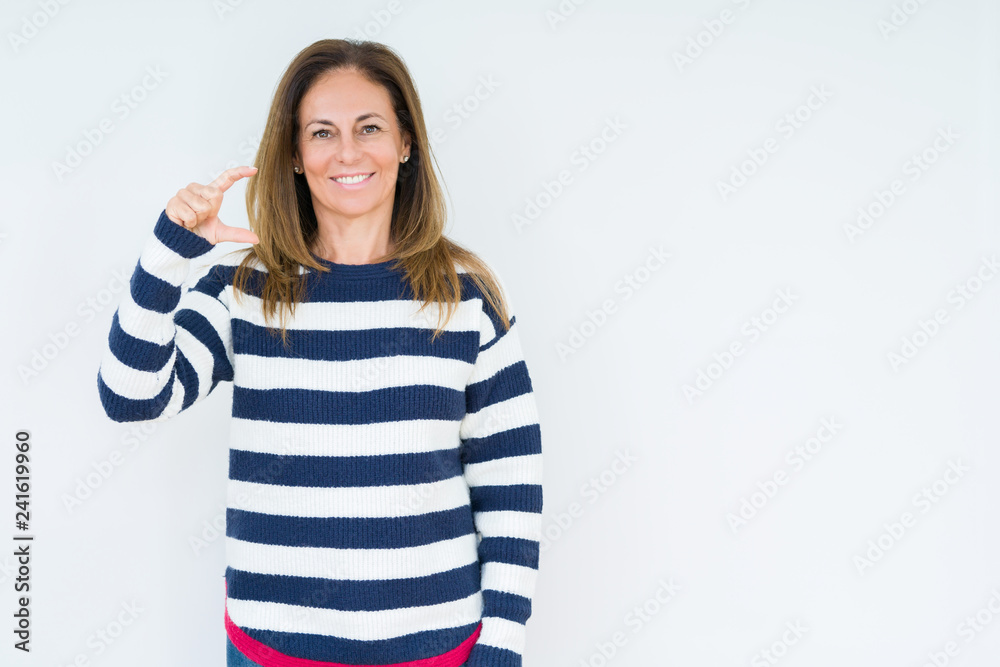 Beautiful middle age woman wearing navy sweater over isolated background smiling and confident gesturing with hand doing size sign with fingers while looking and the camera. Measure concept. Beautiful middle age woman wearing navy sweater over isolated background smiling and confident gesturing with hand doing size sign with fingers while looking and the camera. Measure concept.