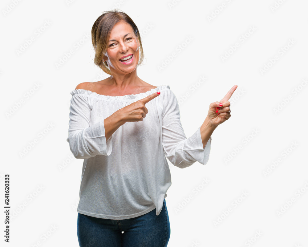 Middle age senior hispanic woman over isolated background smiling and looking at the camera pointing with two hands and fingers to the side. Middle age senior hispanic woman over isolated background smiling and looking at the camera pointing with two hands and fingers to the side.