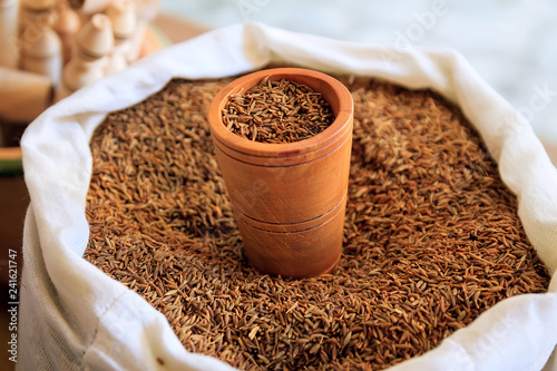 Dried cumin seeds in jute bag
