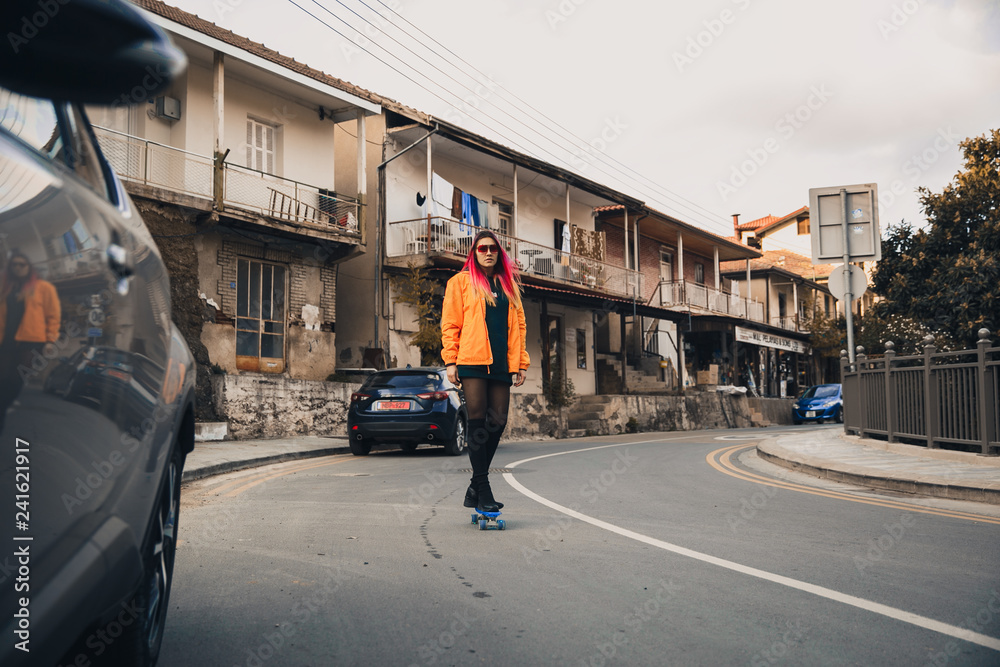Girl on a skateboard on the road Girl on a skateboard on the road