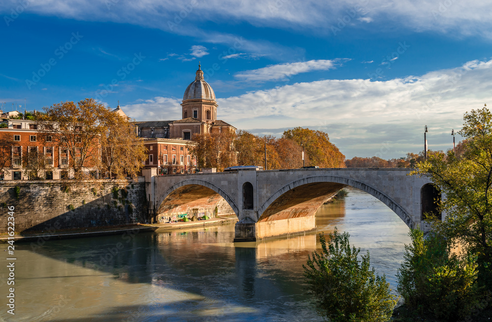 View of Ponte Principe Amedeo Savoia Aosta that spans riber Tiber, with Museo di arte sacra San Giovanni dei Fiorentini in the background. Rome, Italy, December 2018.
