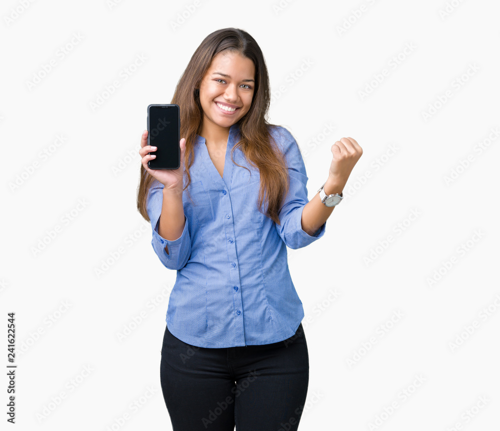 Young beautiful brunette business woman showing screen of smartphone over isolated background screaming proud and celebrating victory and success very excited, cheering emotion Young beautiful brunette business woman showing screen of smartphone over isolated background screaming proud and celebrating victory and success very excited, cheering emotion