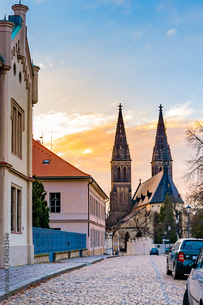 Obraz premium Prague, the Vysehrad cathedral. Ancient and historical church in czech capital city. Look from the street. Basilica during the sunset