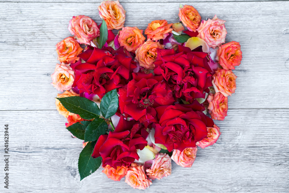heart made of rose flowers on wooden background for Valentines day. Flat lay, heart made of rose flowers on wooden background for Valentines day. Flat lay,